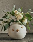 Klondikes Moon Jar Bartblanc with flower arrangement