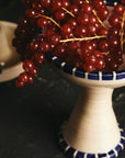 curios dessert bowl hand painted blue design full of cranberries